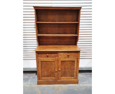 Early 20th century oak dresser, the moulded cornice above two shelves, on a base of two drawers, two cupboard doors, raised t