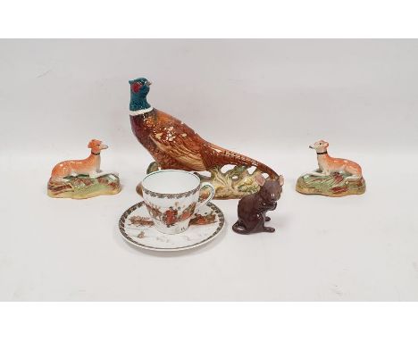 Beswick pottery model of a pheasant naturalistically modelled on rocky ground, 18cm wide, a Royal Doulton coffee cup and sauc