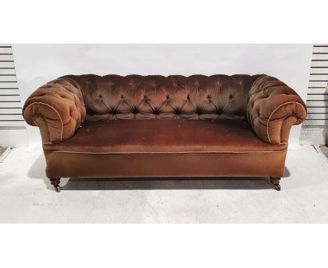 Victorian Chesterfield sofa in brown upholstery, on turned front legs to castorsCondition ReportHeavy fading and discolourati