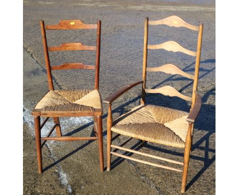 An Arts &amp; Crafts fruitwood ladder back chair with rush envelope seat and a similar rush seat elbow chair