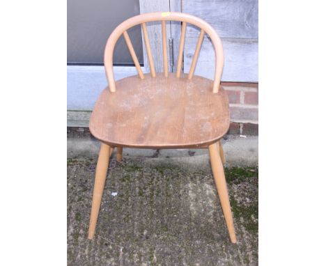 An Ercol spindle low back dressing stool and two rush seat ladder back chairs