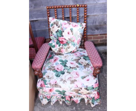 An early 20th century fruitwood bobbin turned open armchair, on castored supports