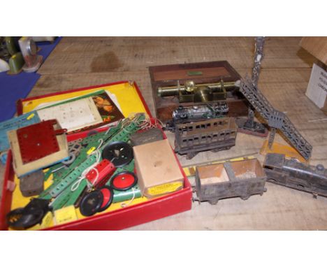 A Meccano clockwork motor, a selection of model train accessories, including carriages and other items