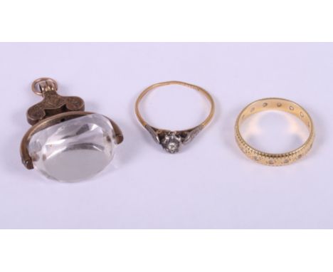 An 18ct gold dress ring set brilliants, a similar 18ct gold single stone ring, 4.6g gross, and a 19th century yellow metal mo