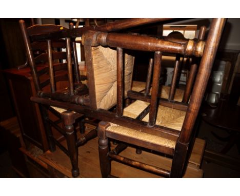 A set of six ash ladder back chairs with rush envelope seats, on turned and stretchered supports