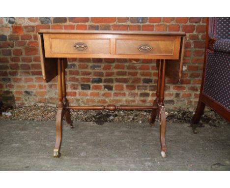 A mahogany sofa table, fitted two drawers, on splayed castored supports, 50" wide (when fully extended)