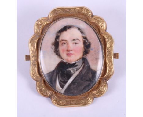An early Victorian portrait miniature of an unknown gentleman, in engraved yellow metal oval mount, 1 1/2" x 1 1/4"