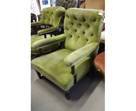 A late Victorian ebonised and gilt frame open armchair, button upholstered in a green velvet, on castored supports