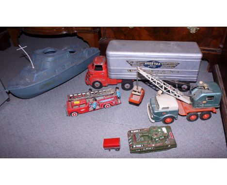 A selection of tin-plate toys, including a fire engine, a Grey Van Lines lorry, an M-35 tank and a truck