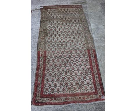 A Persian tribal rug with all-over "carnation" design on a light ground, 44" x 92" approx