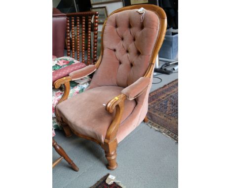 A Victorian walnut showframe spoon back chair, button upholstered in a pink velour, on turned supports
