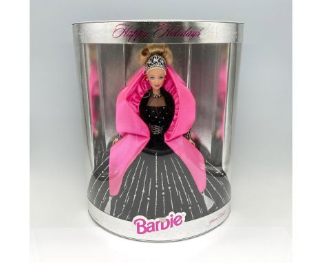 Gorgeous Barbie doll dressed in black velvet dress adorned with pink satin scarf. This item comes new sealed in original box.