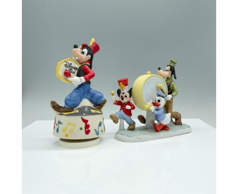 A set of two Disney items that include a whimsical music box featuring Goofy in a vibrant marching band uniform playing a dru