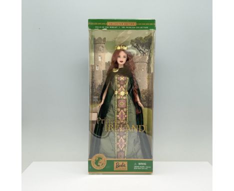 A red-haired woman in a green Celtic dress with pink and gold patterns, elegantly draped with a matching green velvet cloak. 