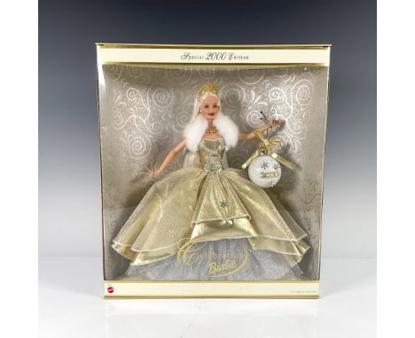 Special 2000 Edition. New in original sealed box. She is dressed in a feathered sleeveless gold organza layered ball gown wit