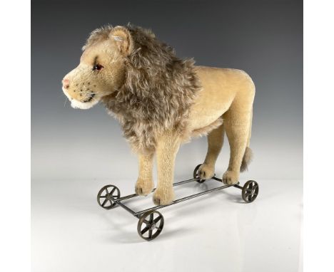 Beautiful 2007 limited reproduction pull toy on cast spoke wheels, with glass eyes and name tag. Steiff button, white tag wit