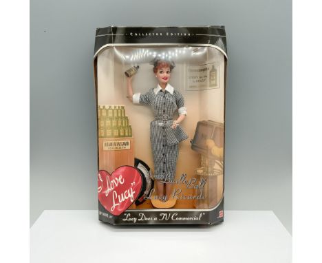 Lucille Ball captivatingly dressed in a white and black patterned dress, complete with spoon and bottle in hand, striking a p