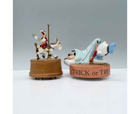 Two enchanting music boxes, one from Willits Designs featuring Goofy in a red suit strumming a banjo atop his steed, while th