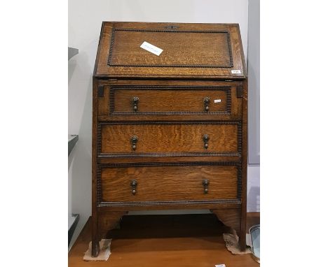 20th century oak bureau, the fall front enclosing pigeonholes, with three long drawers below, raised on bracket feet, width 6