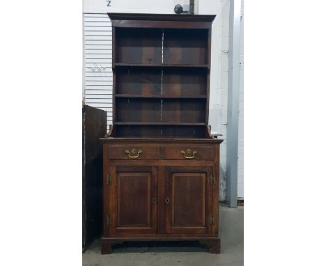 19th century oak dresser having flat moulded cornice, three open shelves over a cupboard base and fitted two drawers to friez