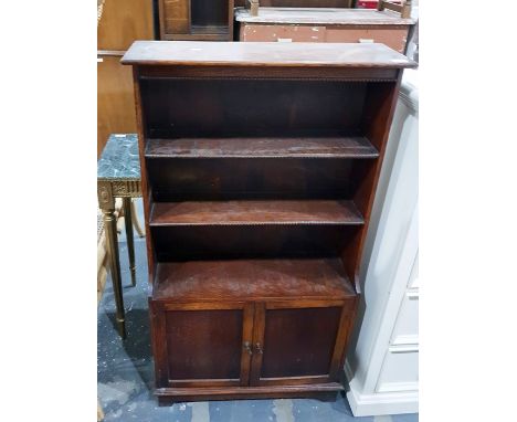 Oak shelving unit with three shelves above two cupboard doors, to bracket feet, 64.5cm 