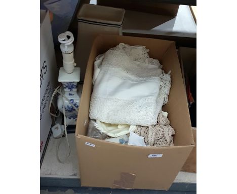Cotton and crocheted tablecloth, other table linen and a ceramic table lamp, white with blue flowers with blue and cream lamp