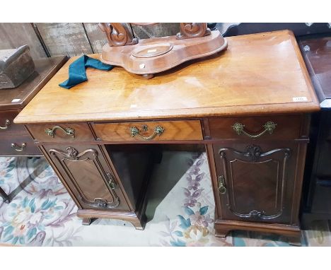 Late 19th century mahogany kneehole pedestal desk having fitted three drawers to frieze, the two pedestal cupboards with pane