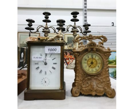 French carriage clock with enamel dial, with strike, repeat and alarm, an early 20th century mantel clock in a cast iron moun