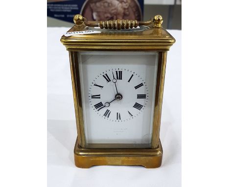 French carriage clock with enamel dial and Roman numerals, the glazed panels within a gilt brass case, retailed by Harrods Li