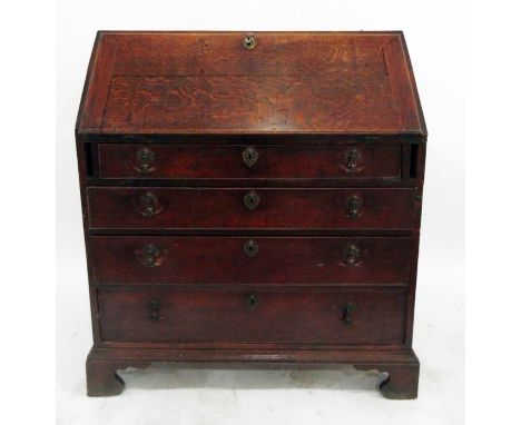 Early 19th century oak bureau, the fall revealing a fitted interior and over one shallow and three graduated long drawers, on