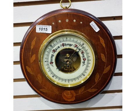 Aneroid barometer with an enamel dial and within an inlaid floral case 