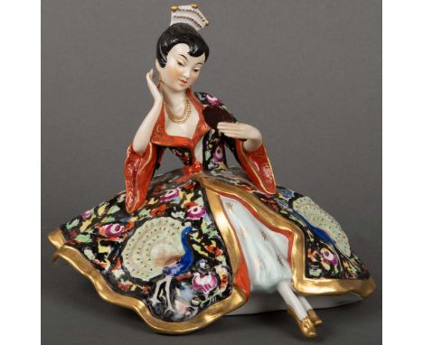 Sitzende asiatische Frau mit Spiegel. Sitzendorf 20. Jh. Porzellan, bunt bemalt, am Boden gemarkt, H=16 cm.