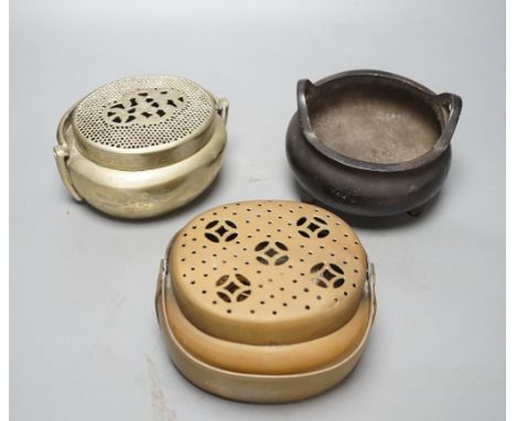 A Chinese bronze tripod censer, 13.5cm and two brass or bronze hand warmers