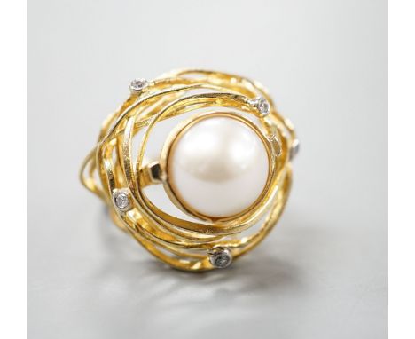 A modern 750 yellow metal, mabe pearl and diamond chip set modernist dress ring, size Q, gross 13.2 grams.