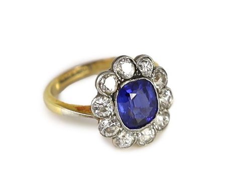 An 18ct gold and platinum, synthetic sapphire and diamond set oval cluster ring,size H, gross weight 3.4 grams.