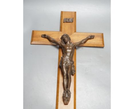 A bronze crucifix, mounted on a wooden cross,Height of cross, 60.5 cms.