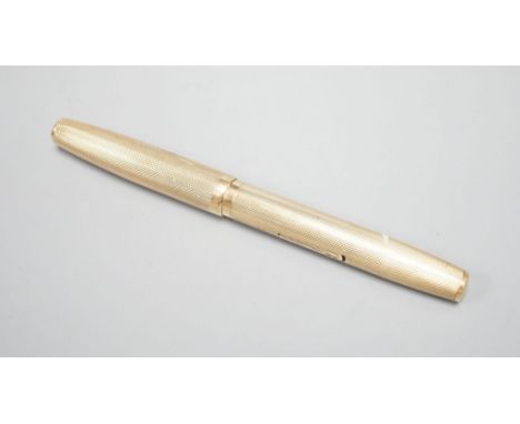 A 1940's Waterman's engine turned 9ct gold cased fountain pen, 12.9cm,gross weight 25.1 grams.