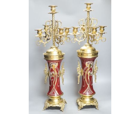 A pair of large brass and ceramic mounted candelabra,64.5 cms high.