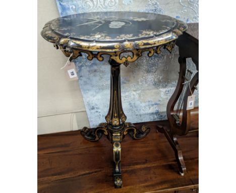 A Victorian mother of pearl inlaid gilt decorated circular  tilt top papier mache tripod wine table, diameter 51cm, height 74