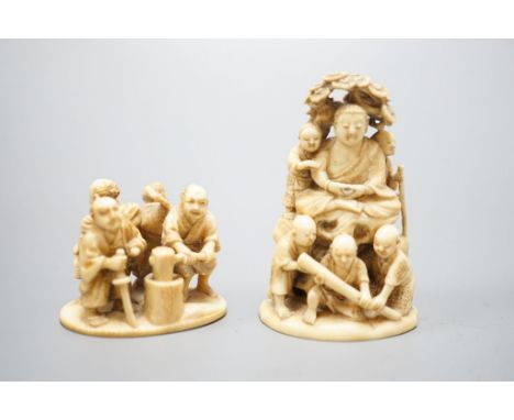 Two Japanese ivory okimono-netsuke of Buddha and attendants and a group of artisans, Meiji period, both signed, tallest 7cm