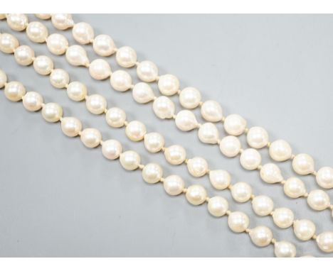 A modern long single strand cultured pearl necklace, with fluted 14k and diamond chip set clasp, 116cm.