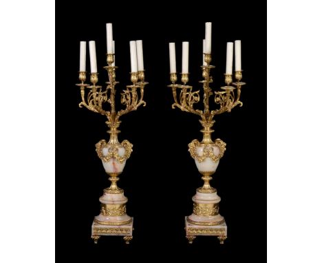  A pair of gilt metal mounted onyx six light candelabra in Louis XV taste,   last quarter 20th century, each with five urn so