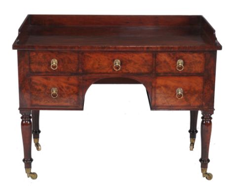  A George IV mahogany dressing table  , circa 1825, the three-quater galleried top above an arrangement of five drawers and a