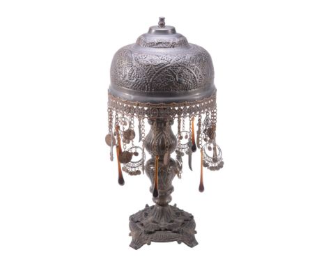  A north African brass standard lamp,   20th century, the domed shade pierced and embossed with stylised foliate motifs, the 