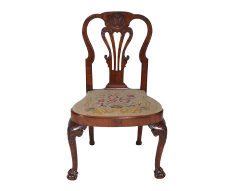  A George I walnut side chair  , circa 1710, the curved top rail with central shell motif above bird head and scroll carved v