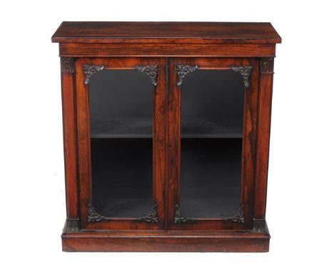  A William IV rosewood side cabinet,   circa 1835, the rectangular top above a pair of glazed doors enclosing single shelf, f