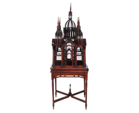  A mahogany birdcage,   20th century, of architectural form, the stand incorporating turned tapered legs centred by an x-shap