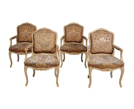  A set of four French cream painted and parcel gilt armchairs in Louis XV style  , early 20th century, each moulded back with