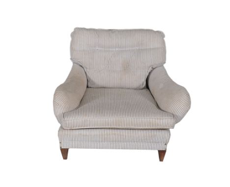  A Victorian upholstered armchair in the manner of Howard  &  Sons  , circa 1890, with loose cushion back and seat, on square