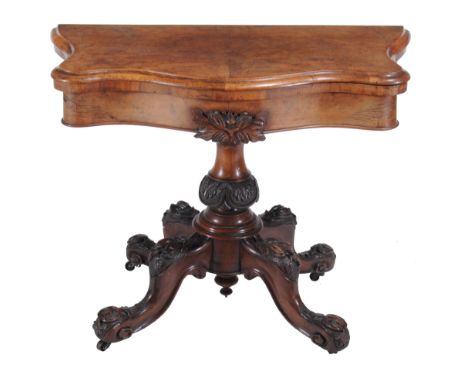  A Victorian walnut card table  , circa 1860, of serpentine outline, the top opening and revolving to baize playing surface a